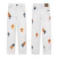 White denim with orange and blue leopard cross patches