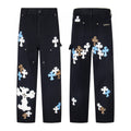 Black carpenter pants with white, blue and leopard cross patches