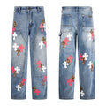 Blue denim carpenter pants with pink, white and leopard cross patches