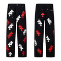 Black carpenter pants with red and white cross patches